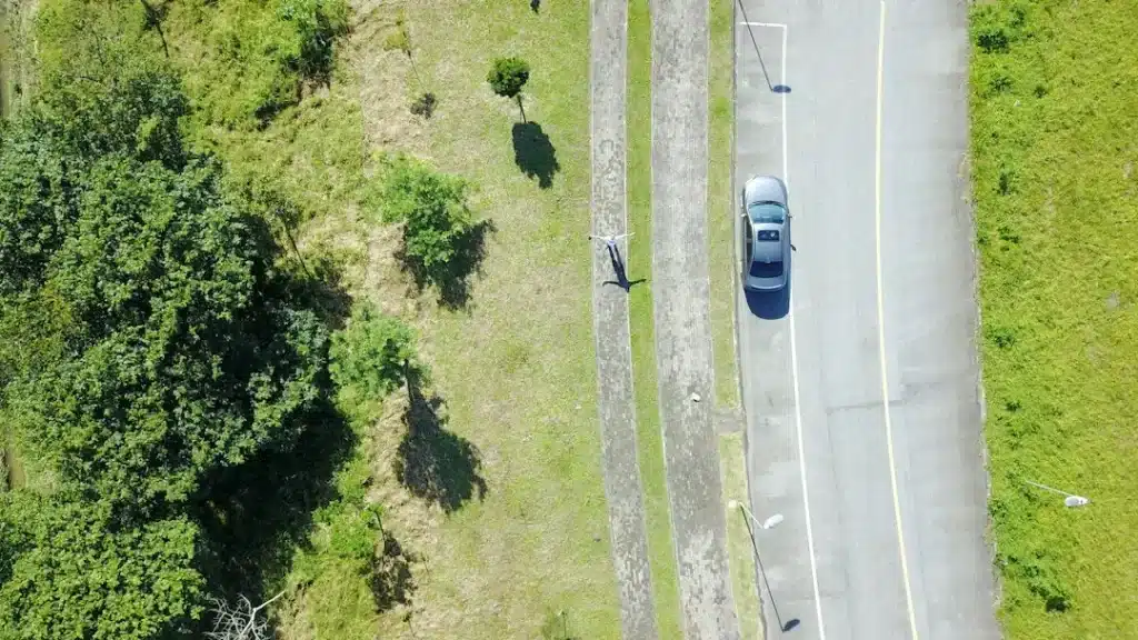 Aerial view of a hybrid car driving on a road